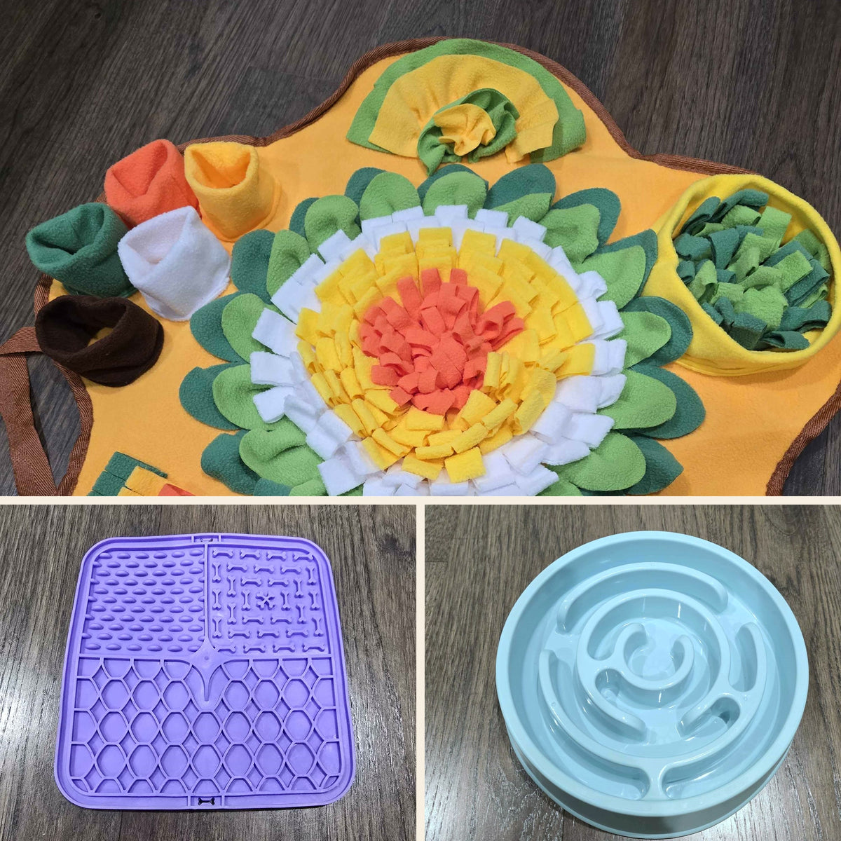 The Boredom Buster Kit laid out on a wood floor: a yellow flower-shaped snuffle mat with fleece petals and hidden pockets, a purple textured lick mat, and a light blue spiral maze slow feeder bowl.